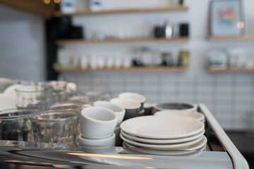 A kitchen countertop and a sink with dishes.
