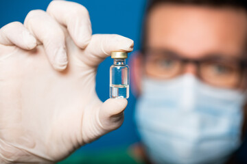 doctor holding covid - 19 coronavirus vaccine