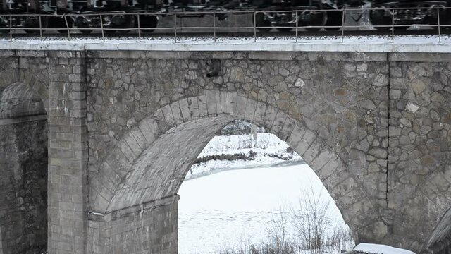 Vintage stone arched railway bridge and train
