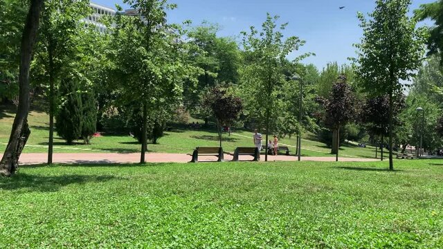 Time lapse footage of young people walking and relaxing at city park called "Macka Demokrasi Parki" in Istanbul. Urban youth culture concept. It is a sunny summer day.