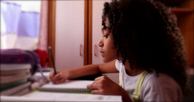 Cute little school gir writing notes doing homework