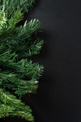 Christmas new year composition on black background. Fir branches, christmas decoration. Flat lay, top view, copy space