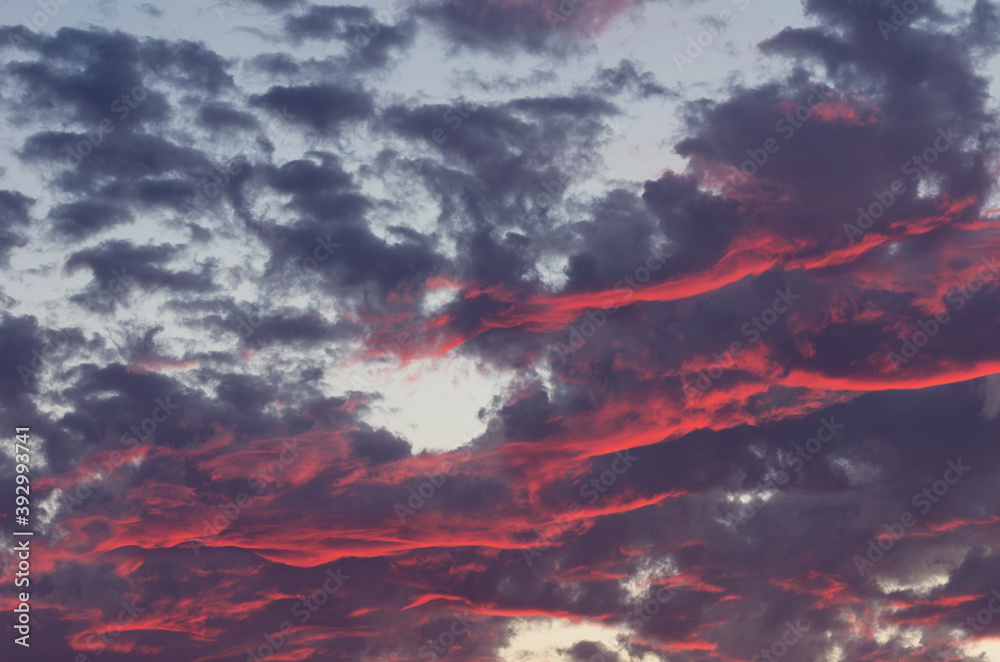 Wall mural red and dark clouds against a light blue sky. image useful as graphic resources. sky background and 