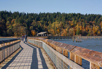 A couple walks along a beautiful boardwalk at Billy Frank Jr. Nisqually National Wildlife Refuge in...