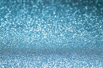 Abstract textured festive sparkling blue defocus lights background, selective focus