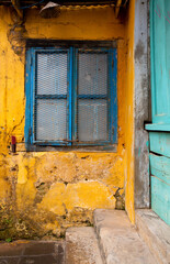 Colorful, weathered, ancient wall and window in Hoi An, Vietnam
