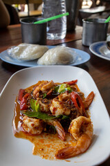 Thai stir fried shrimps with red chili paste, selective focus