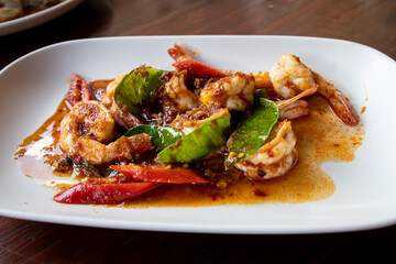 Thai stir fried shrimps with red chili paste, selective focus
