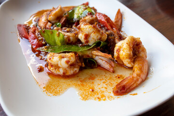 Thai stir fried shrimps with red chili paste, selective focus