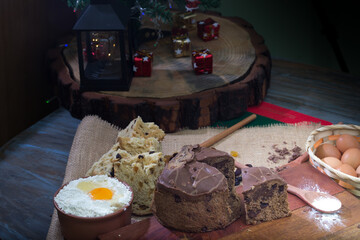 Christmas table. making panettone. with chocolate and raisin panettone. rustic table with wood and dark background. copy space