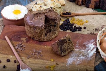 Christmas table. making panettone. with chocolate and raisin panettone. rustic table with wood and dark background. copy space
