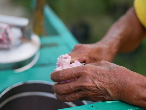 A traditional Indonesian ice cream seller serving customers. Es puter street vendors are serving buyers.