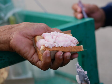 A traditional Indonesian ice cream seller serving customers. Es puter street vendors are serving buyers.