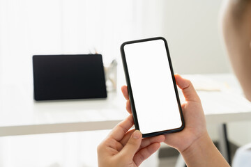 Woman hand holding smartphone and the screen is blank, social network concept, copy space for your advertising.