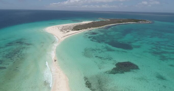 Los Roques venezuela, Cayo de agua  Aerial  Birds Eye View titling downwards while tracking backwards. landscape in paradise island  caribbean beach scene