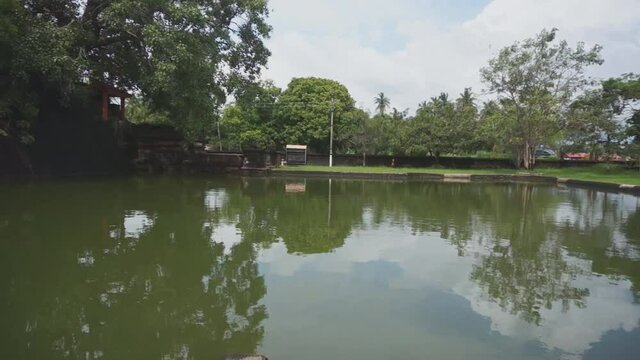 Beautiful temple pool with bodhi tree inside a sacred courtyard in India