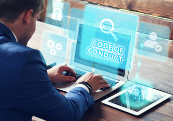 Business, Technology, Internet and network concept. Young businessman working on a virtual screen of the future and sees the inscription: Code of conduct