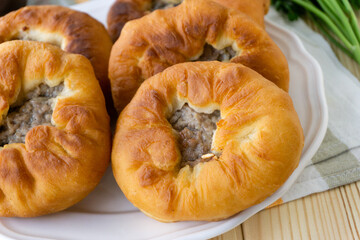 Traditional tatar and bashkir dish belyashi. Open fried pies with minced meat and onions