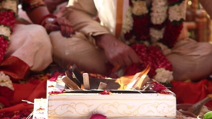 Hindu couple praying to Fire God during their wedding ceremony. Traditional south indian, asian themed wedding. Bengali style.