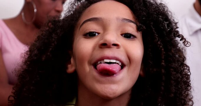 Ehtnically Diverse Little Girl Sticking Tongue Out