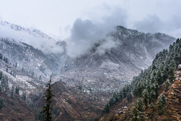 Beautiful winter landscape of Himalayas mountains with snow covered trees in Parvati Valley, Himachal Pradesh.