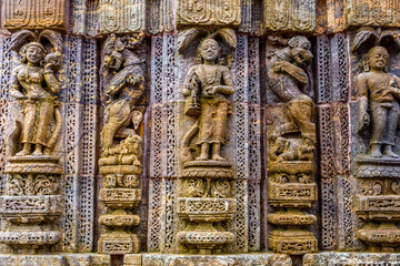 Ancient sandstone carvings on the walls of the ancient sun temple at Konark, India.
