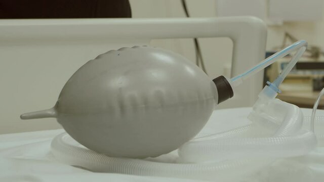 Breathing bag with valve inflates and deflates on hospital bed, 