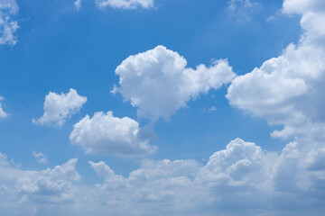 Naklejka na ściany i meble Upward view white fluffy clouds on vivid blue sky in a sunny day