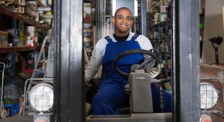 Fototapeta na wymiar Forklift driver at the warehouse of a hardware store