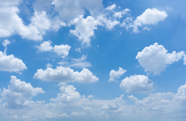 Fototapeta na wymiar Upward view white fluffy clouds on vivid blue sky in a sunny day
