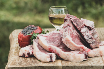 Raw beef steak with baked peppers and white wine
