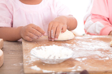 Chinese little girl learning to make moon cakes by hand