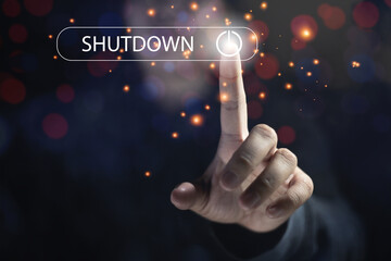 Man hand pressing the Shutdown button on virtual screen. Concept stops working against copy space...