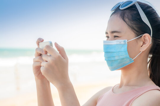 Asian Women Thai People Travel On Sea Beach Thailand Keep New Normal Social Distancing To Protect Coronavirus Covid 19. And Then Support Thailand Domestic Tourism To Stimulate The Economy