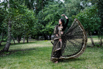 Portrait of a female model in ethnic indian costume with jewellery and traditional makeup.