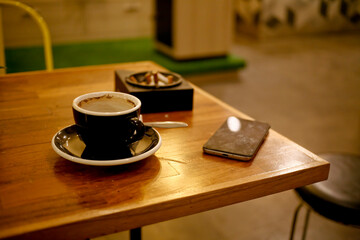cup of coffee on wooden table