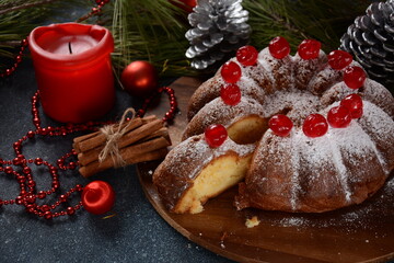 Christmas and New Year concept. Delicious lemon cake with red sweet cherries and sugar powder.