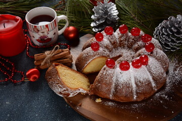 Christmas and New Year concept. Delicious lemon cake with red sweet cherries and sugar powder.