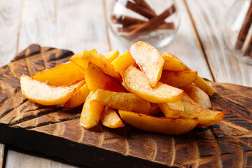 Baked potato wedges on the wooden board
