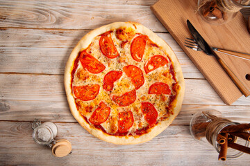 Top view on margherita pizza with tomatoes