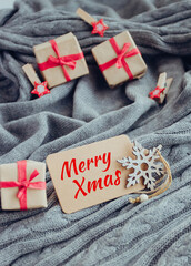 Merry Christmas card, gift boxes and decorations on cozy gray background. - 393019322