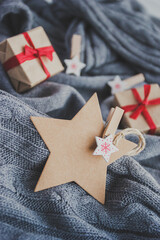 Star shaped blank label on gray background with Christmas gift boxes and New Year decorations. - 393019335