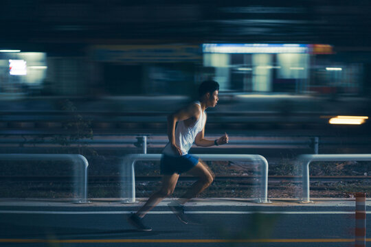 Asian Man Exercise Practicing Running At Night