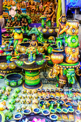 Traditional colorful god statues & souvenir shop at Dilli Haat, New Delhi. Dilli Haat is a craft market located run by Delhi Tourism and Transportation Corporation