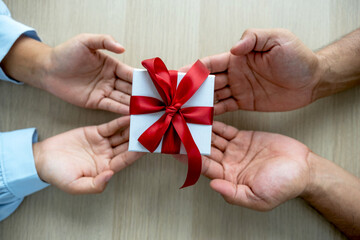 Gift box in hands, Men's hands are giving gifts to women's hands at the festival of special holidays like Christmas, New Year or Valentine's Day