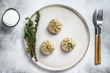 Fototapeta na wymiar Asian Steamed Dumplings Manti with mince meat on a plate. White background. Top view