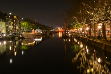The colorful river of the old port of Vlaardingen crosses in the night
