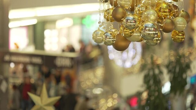 Unrecognizable shopping mall in Christmas lights, many people shoppig stock video.
