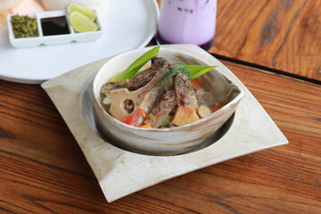 Beef Rib Soup or Sop Iga with Tomato, Carrots, and Potato.