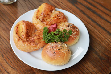 Fresh homemade bread on white plate.